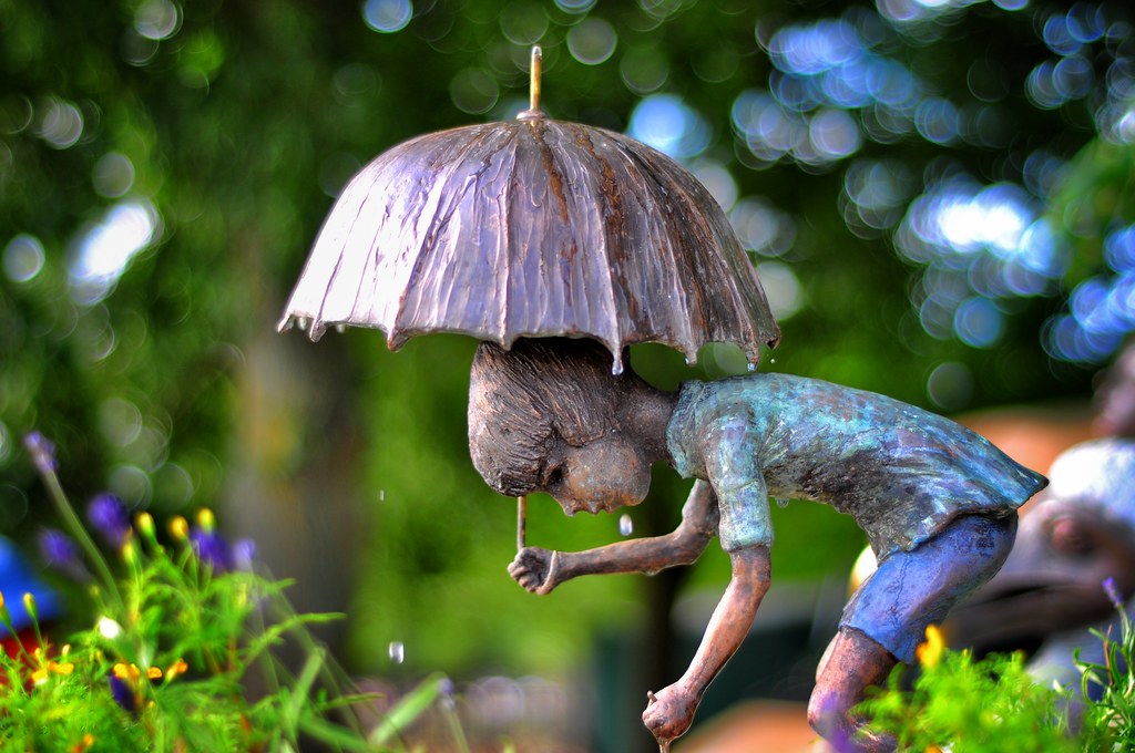 Kid with umbrella statue